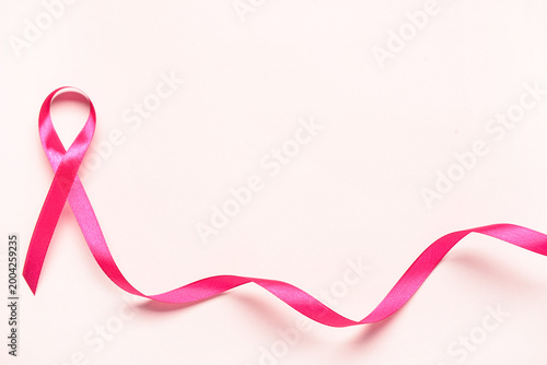 Pink awareness ribbon on wh...