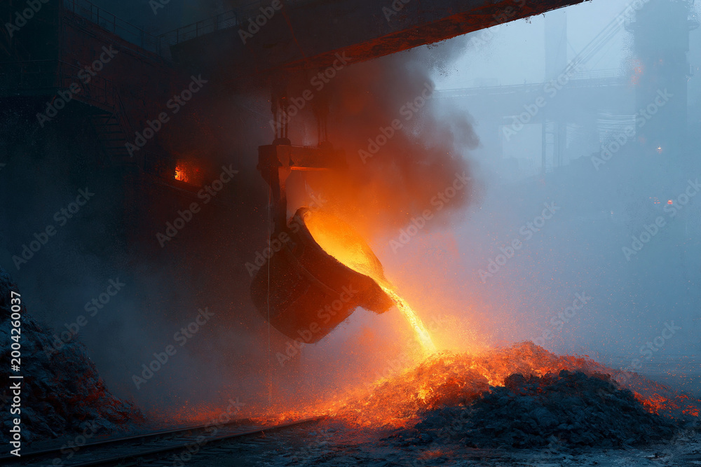 Fototapeta premium Molten metal pours from a casting bucket. Smoke billows as hot steel hits the ground. Fusion light glows, intense and powerful. Industrial machinery dominates the smoky scene. The image conveys raw
