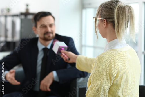 Female journalist with micr...