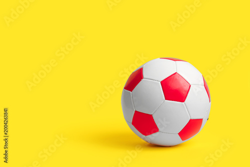 Soccer ball on yellow backg...