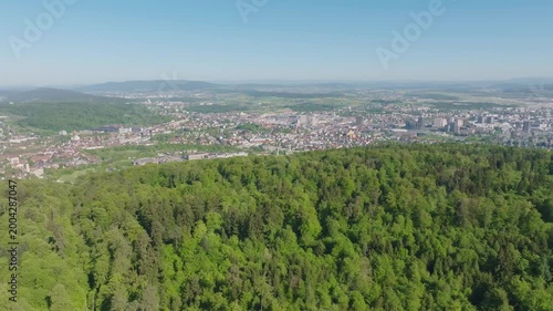Aerial view of Swiss city of Zürich with 360 degree view, Lake Zurich und Swiss Alps in the background on a sunny spring day. Video shot April 30th, 2026, Zurich, Switzerland.