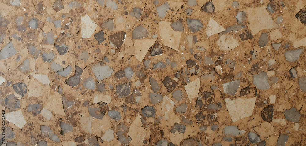 Fototapeta premium Terrazzo floor or surface with small stones and chips in brown, beige, and gray tones
