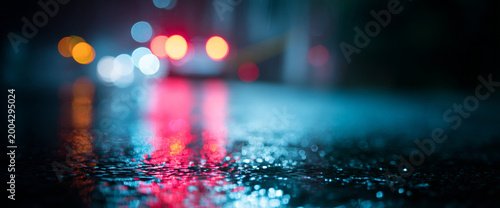 Wet street with colorful blurred lights