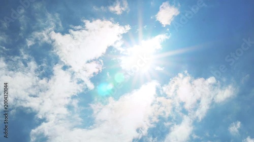 Sunny azure blue sky sun white puffy fluffy clouds, clean pure blue skyscraper in sunlight sun rays sunbeams glow daylight sunshine aerial drone view, airplane window view, time lapse, slow motion 4K