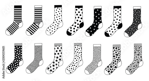 Large assortment of socks featuring diverse patterns like stripes, polka dots, stars, and abstract shapes in a black and white display.