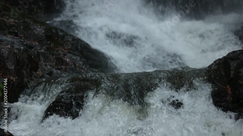Close up of flowing waterfall stream, clear fresh natural water and peaceful wild nature landscape
