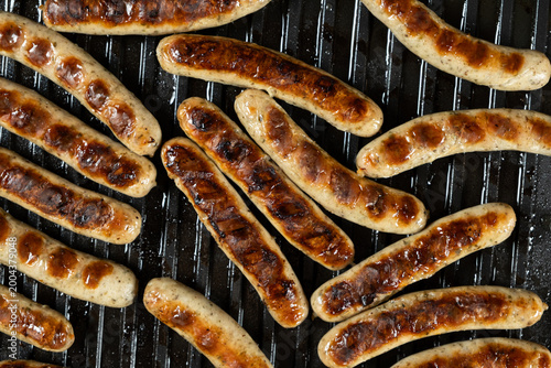 Photos Delicious Pork Sausages Roasting on Contact Grill Surface