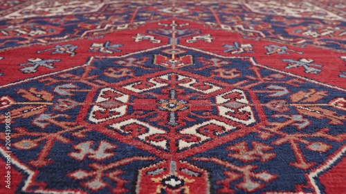 Traditional Persian rug panning close up revealing intricate handwoven medallion pattern for home decor and cultural content