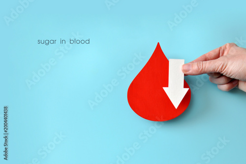 Low Blood Sugar Level Concept with Red Drop and Down Arrow