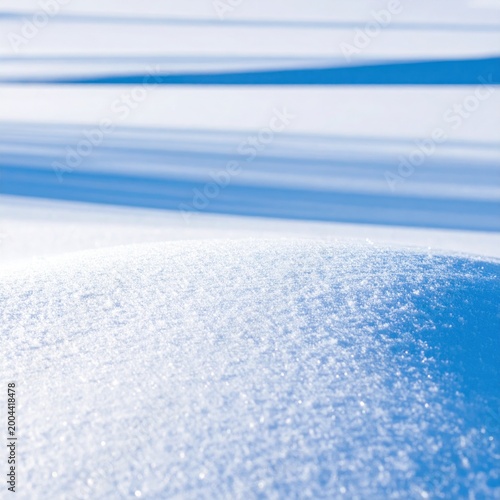 Fresh snow drift texture closeup, deep blue shadows casting lines on sparkling icy surface, winter landscape background, cold weather atmosphere