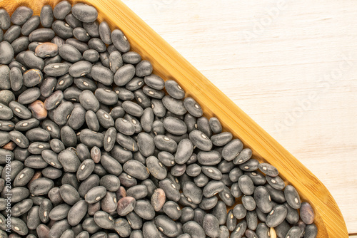 Dried beans, on a wooden table. Top view.