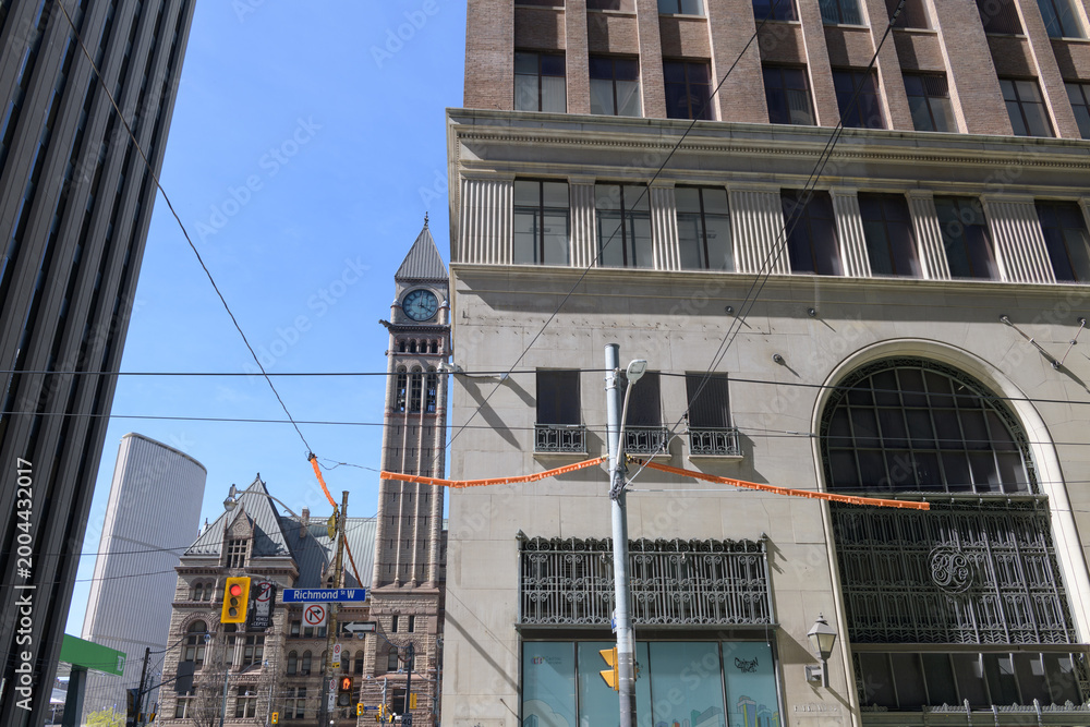 Fototapeta premium historic Robert Simpson department store, designed by Chapman & Oxley, 1928-1929, corner of Bay St and Richmond St W (with view of clock bell tower of Old City Hall), Toronto