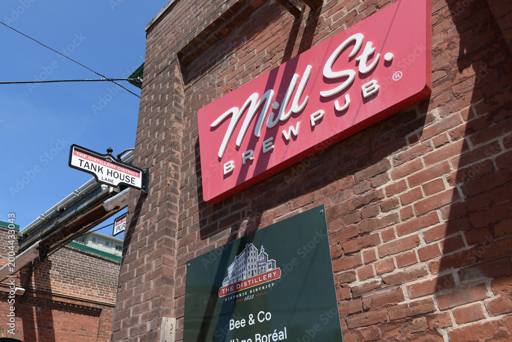 Fototapeta premium exterior building and sign of Mill Street Brewpub located in the Distillery historic District, 21 Tank House Lane, Toronto