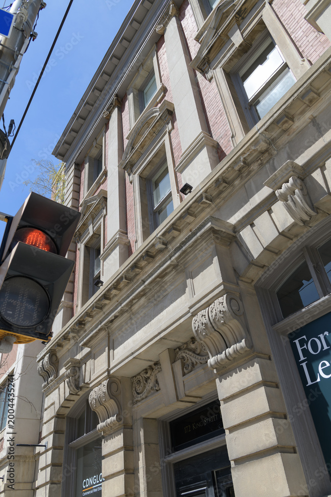 Fototapeta premium oblique angle view of The Sovereign Bank, designed by George W Gouinlock in Beaux-Arts, Renaissance Revival, 1907, at 172 King St E, Toronto