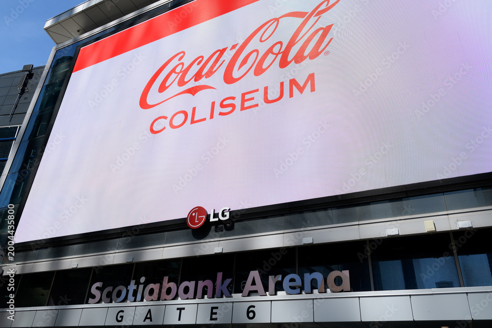 Obraz premium Coca-Cola Coliseum advertising on the big LG electronic sign outside Scotiabank Arena, Maple Leaf Square/Jurassic Park entrance, Bremner Blvd, Toronto