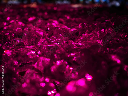Abstract glowing pink crystals and gemstone texture in macro view with neon illumination