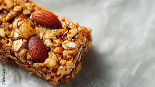 Close-up of an almond granola bar with whole almonds on top healthy snack energy bar food ingredient