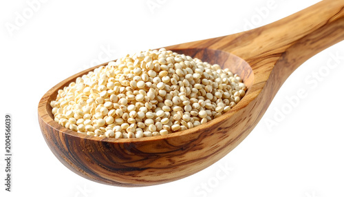 Close-up of white quinoa seeds filling a wooden spoon, isolated on a black background