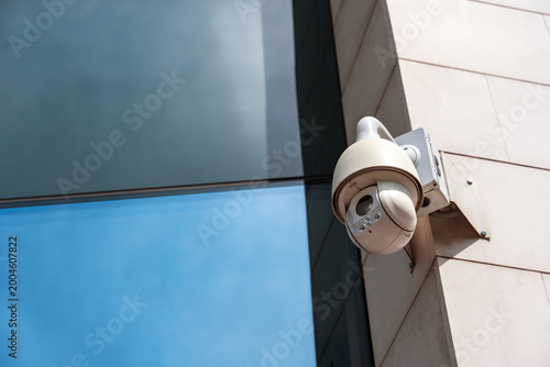 360-degree outdoor surveillance camera installed near a building window
