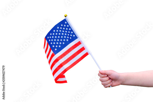 Photo of child hand holding small USA flag isolated on white transparent background. Patriotic concept perfect for Independence Day, education, celebrations and American themed designs. 4th July.