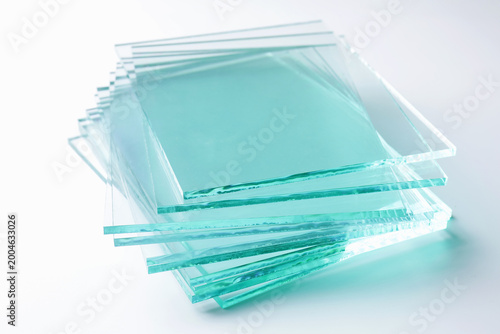 Bild auf Leinwand Stack of glass sheets on light background, closeup