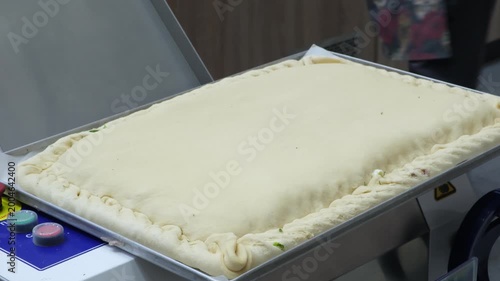 Chef cook is preparing large, delicious pie with vegetable filling for baking. Hands shape pastry with precision. Professional food preparation in kitchen. Ideal for recipes, baking tutorials