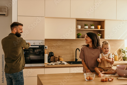 Obraz na płótnie Happy family baking together in modern kitchen at home