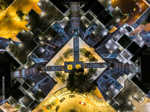 Stunning aerial night view of glowing high rise residential towers in Hong Kong showcases dense urban living and modern architectural scale.