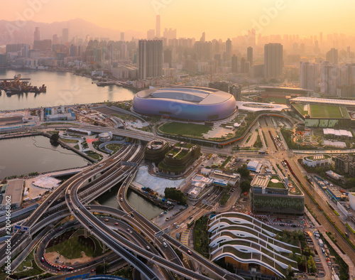 The modern Kai Tak Sports Park in Hong Kong glows during a golden sunset, showcasing the city world class sports infrastructure and urban development.