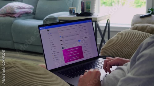 Older man using a laptop to answer social media quiz questions illustrating the dangers of oversharing personal data and cybersecurity risks