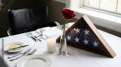 POW MIA remembrance table set with single place setting folded flag and rose centerpiece, symbolic still life close arrangement, ceremonial 3