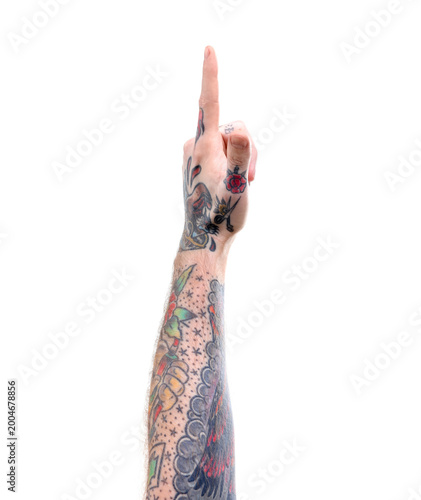 Fotografie Man with tattoos pointing at something on white background, closeup