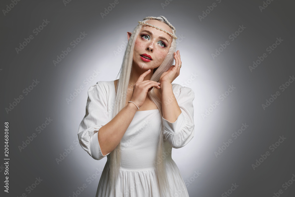Fototapeta premium Beautiful elf girl on grey gradient background