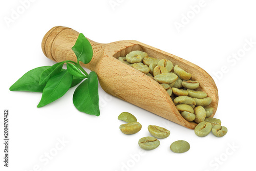 Green coffee beans in wooden scoop isolated on white background