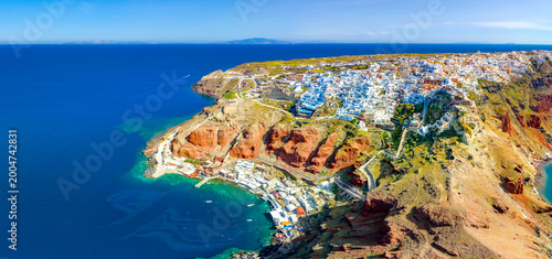 Oia town on Santorini island, Greece. Traditional and famous houses and churches with blue domes over the Caldera, Aegean sea