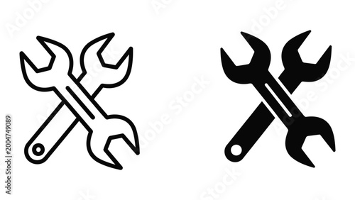 Two crossed wrenches icon in black and white vector style