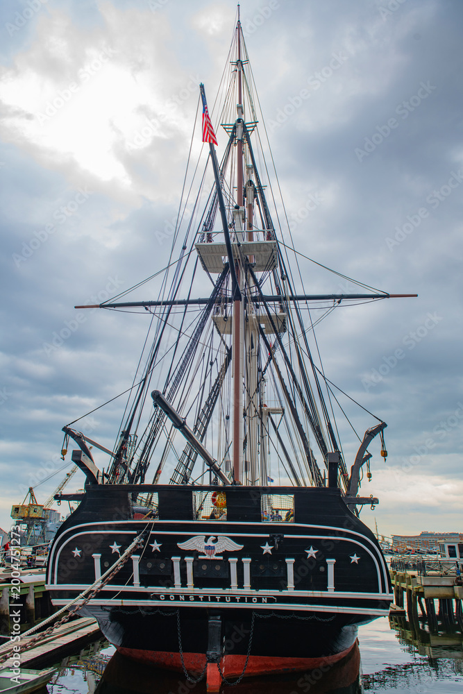 Fototapeta premium USS Constitution is a three masted wooden hulled heavy frigate of the United States Navy docked at Charlestown Navy Yard in Boston, Massachusetts MA, USA. She is the world's oldest ship still afloat. 