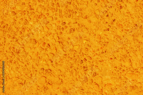 Small stones grain concrete detail slab cement surface structure wall texture backdrop color orange bright paint background pattern abstract