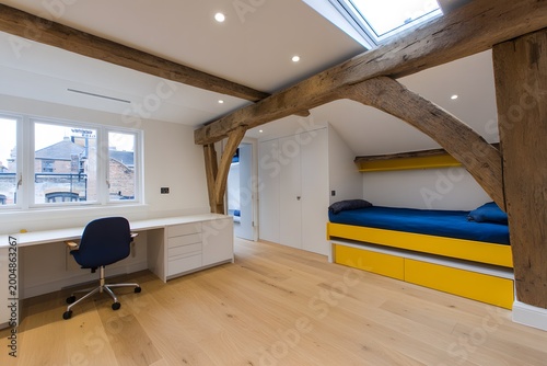 Cozy children's room with yellow and blue accents and wooden beams