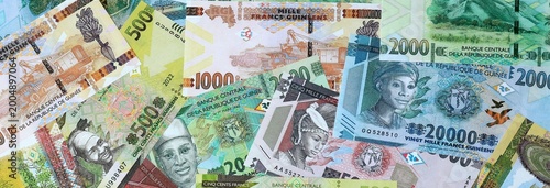 Картината върху платно Guinean franc money banknotes bunch on table