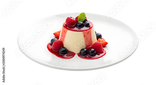 A delicious dessert with creamy white pudding topped with mixed berries on a clean white plate