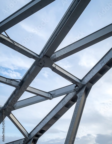 Abstracted steel lattice against cloudy sky