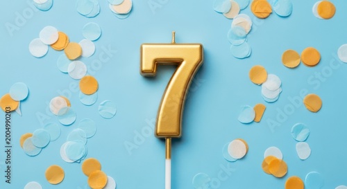 Gold number seven birthday candle on a blue background with colorful confetti