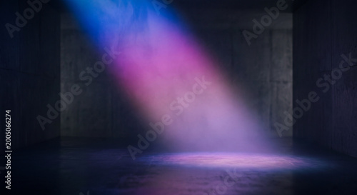 Abstract image of dark empty room with neon pink and blue light illuminating concrete floor and walls.