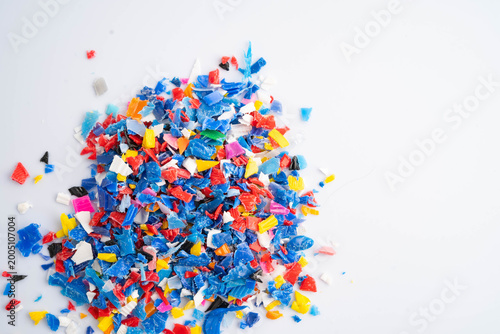 Photos Plastic colorful pieces recycling shredded for industrial use.