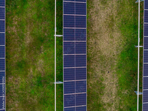 Tablou pe pânză Aerial Top Down View of Solar Panel Farm on Green Grass Field in Corfu Greece Re