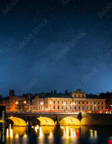 Night View Of Illuminated Old Norrbro Bridge In Stockholm, Sweden