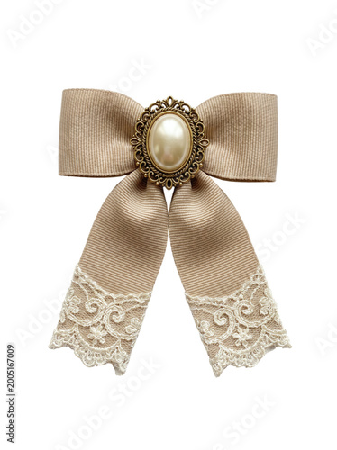 Fotografie Vintage beige ribbon bow decorated with lace ends and antique pearl brooch on a