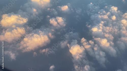 Soft Cloudscape from Above with Golden Sunlight Aerial View