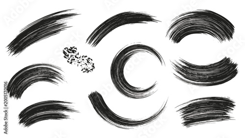 Artistic set of curved black brush strokes and paint splatters, perfect for creating dynamic and abstract circular compositions.